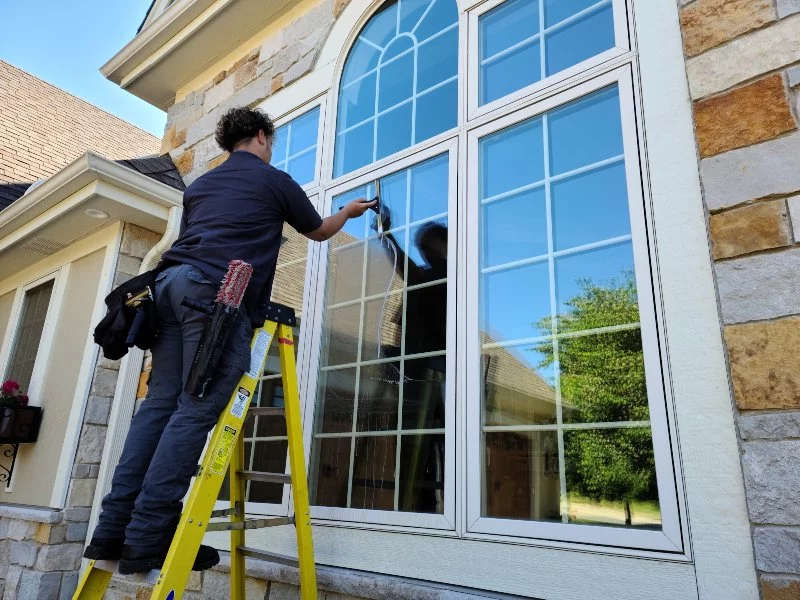 Demarks cleaning professional cleaning windows on brown brick house
